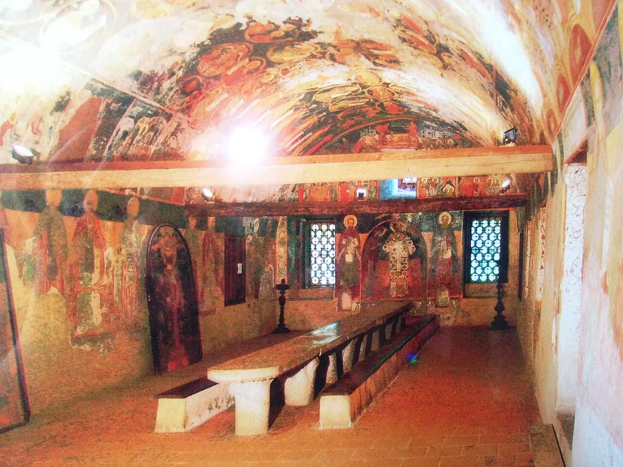 The vaulted interior of the Old Refectory at Bachkovo, its ceiling and walls covered with 17th-century frescoes above a long stone table