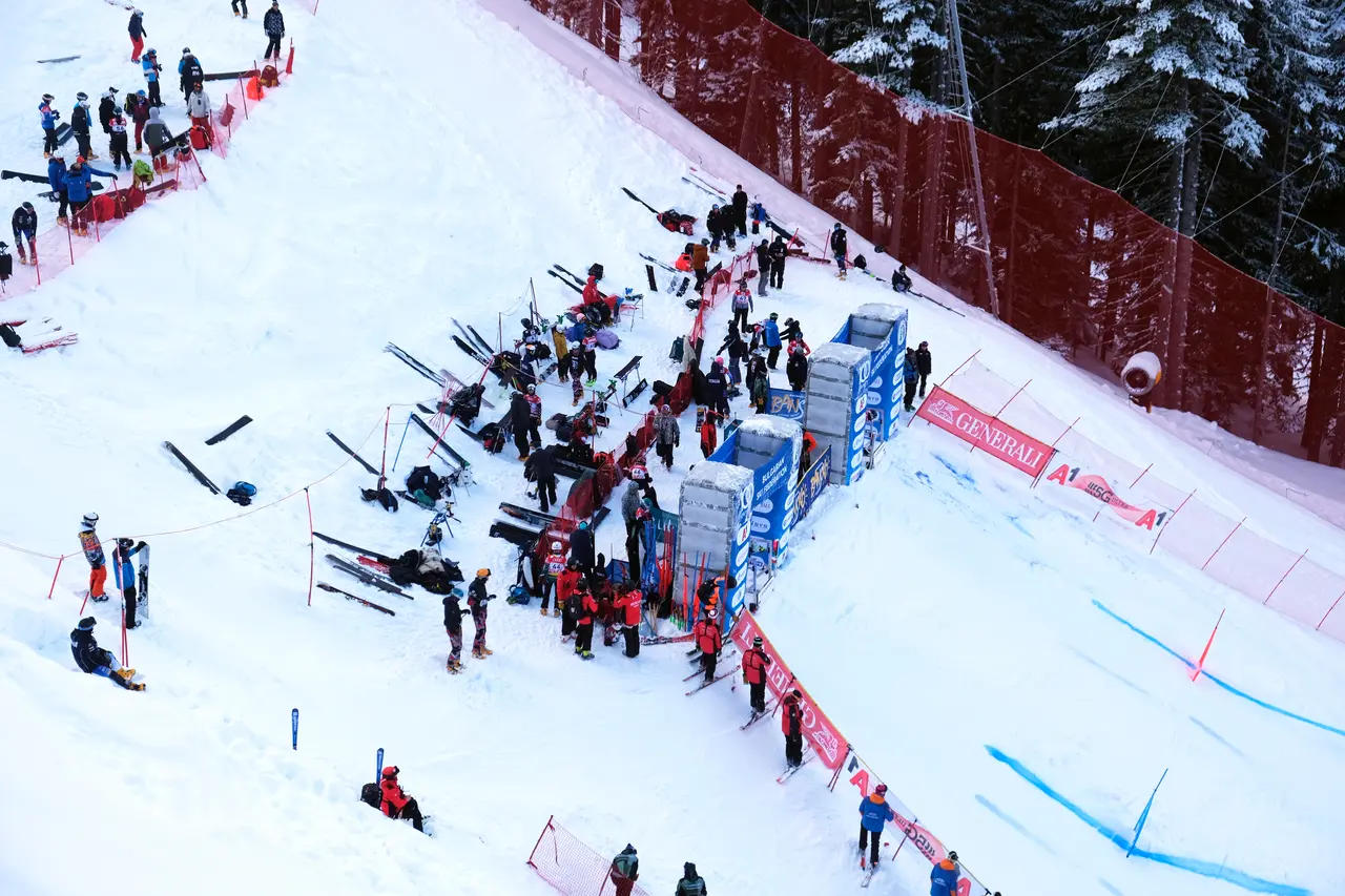Race gates and sponsor boards on a steep Bansko slope during a competition