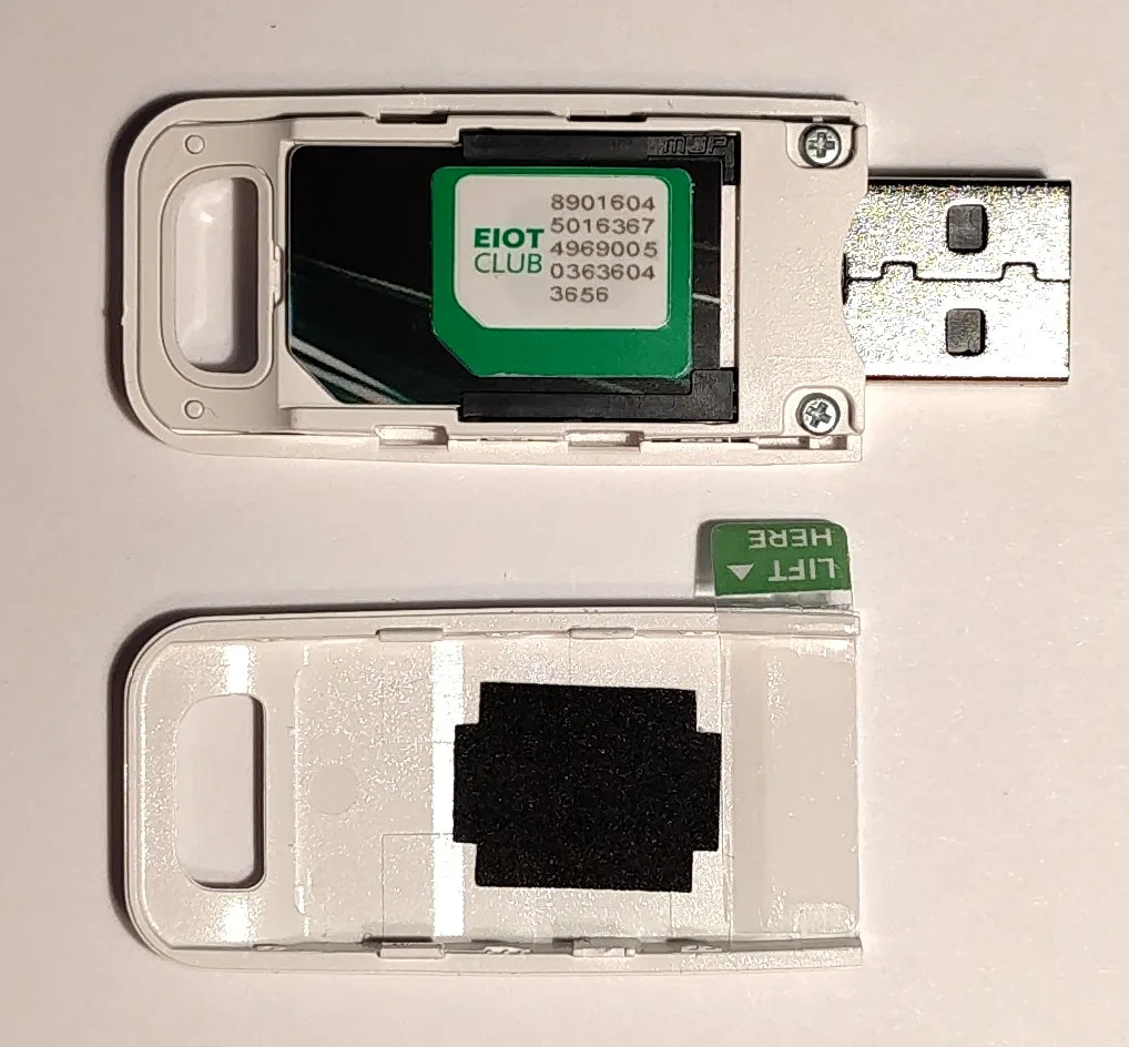 A programmable eSIM chip on a small circuit board sitting in a USB card reader