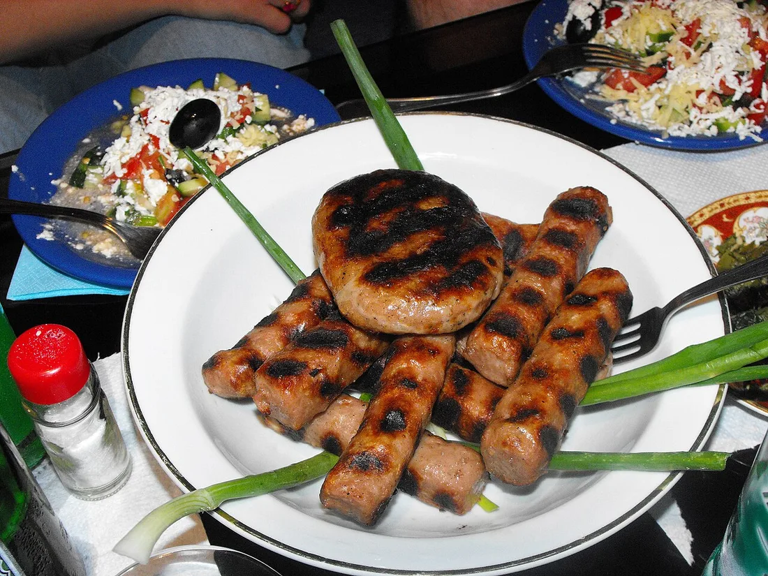 A plate of grilled kebapche, Bulgarian minced-meat rolls, with garnish