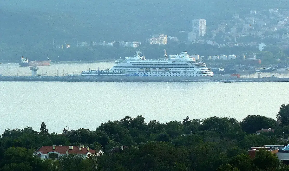 A cruise ship docked in Varna harbour with the city waterfront behind
