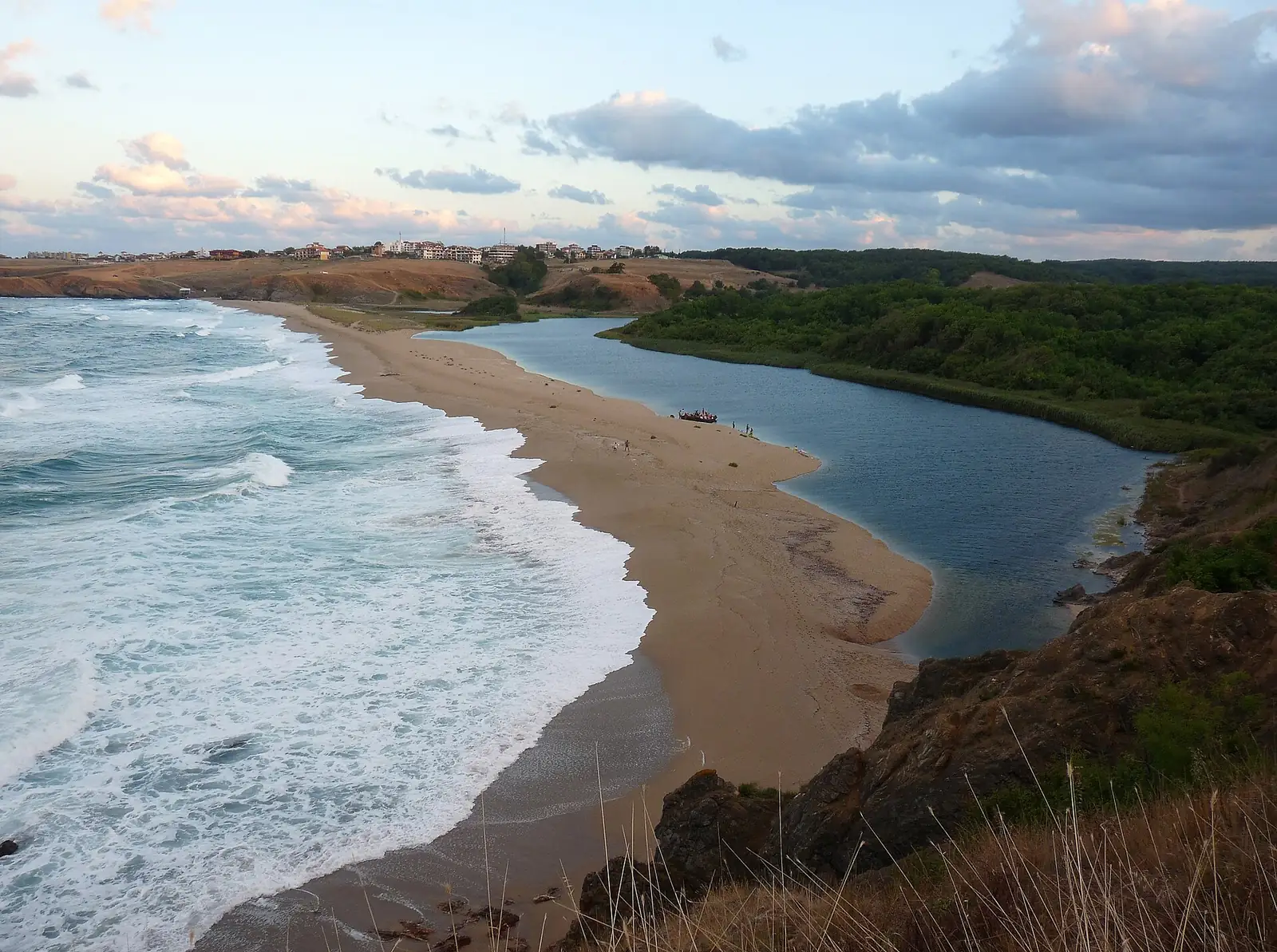 The wide sandy beach at the mouth of the Veleka river near Sinemorets on the southern Black Sea coast, waves rolling in under an evening sky