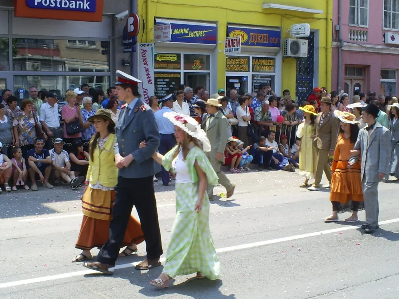 Costumed parade through the streets of Kazanlak during the Rose Festival in early June, crowds lining the road