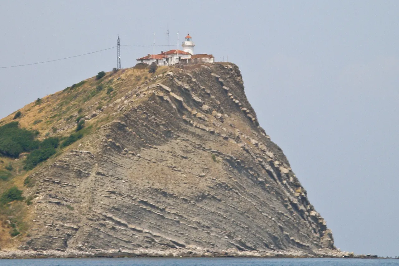 White lighthouse on the grassy headland of Cape Emine above the Black Sea