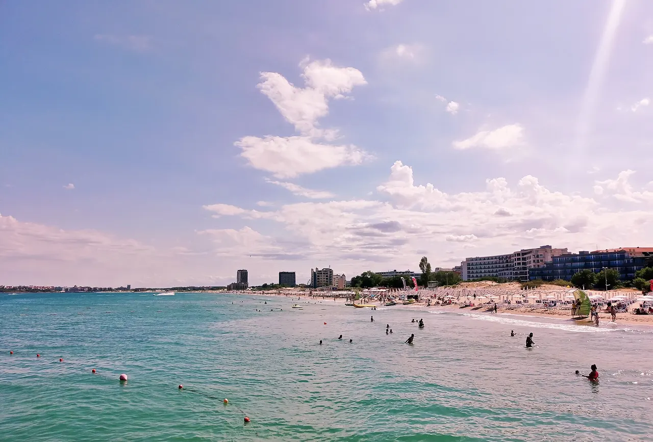 Wide sandy bay at Sunny Beach with hotel blocks along the shore and the Black Sea stretching out