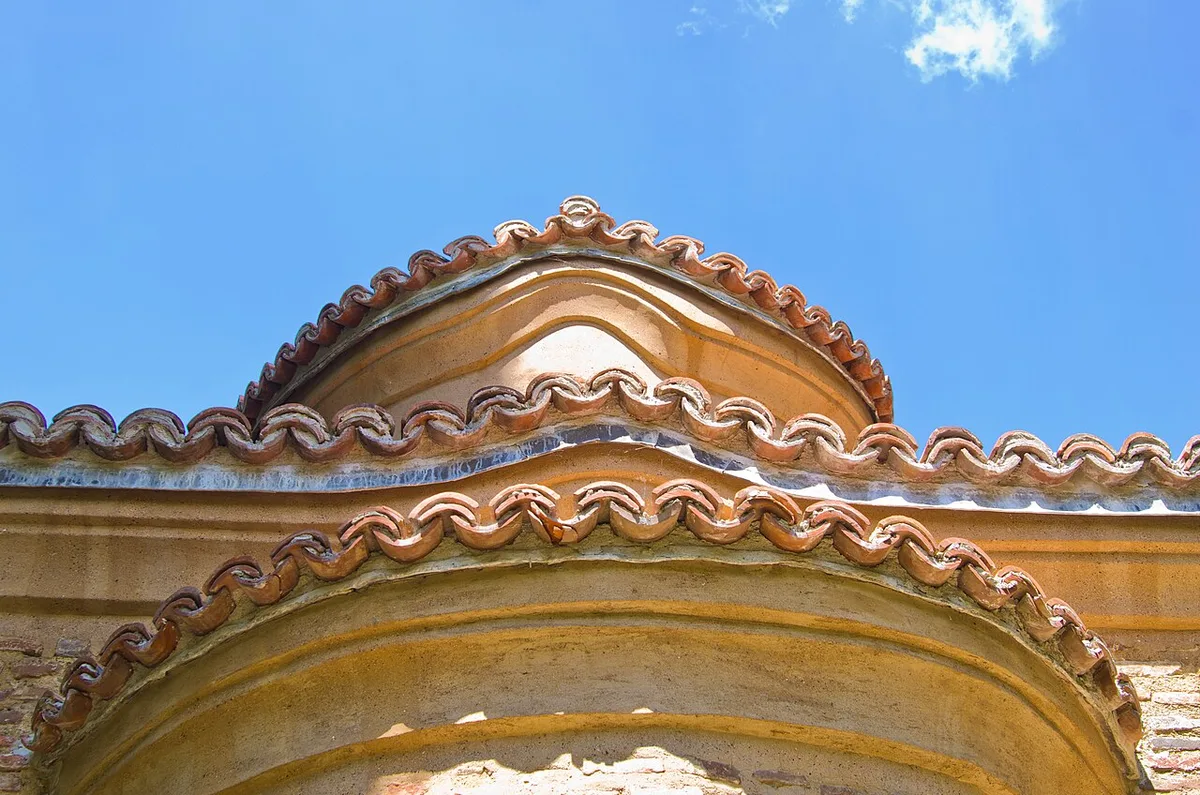 Close view of the tiled eaves and rounded roofline of the 13th-century section of Boyana Church