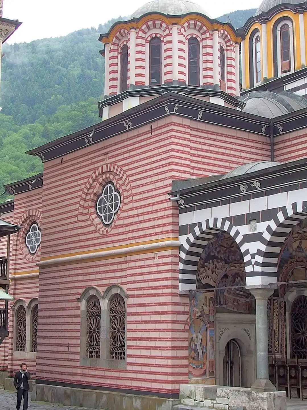 The frescoed portico and bell tower inside the courtyard of Rila Monastery