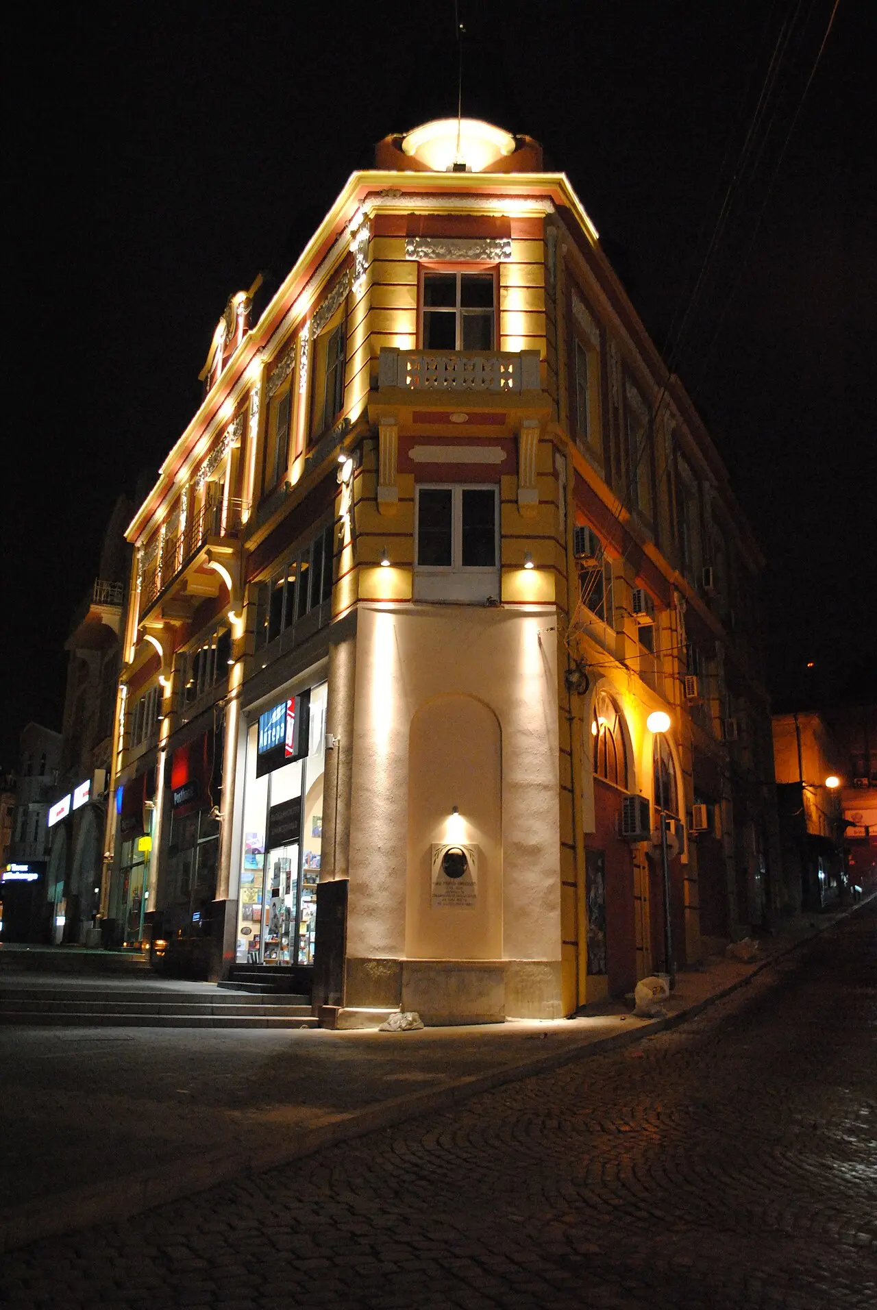Dzhumaya Square in Plovdiv lit at night with people on the square