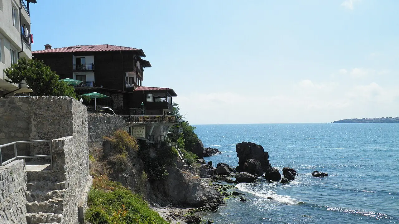 The old town of Sozopol on its rocky peninsula, black-timbered National Revival houses perched above a stone sea wall and the blue Black Sea