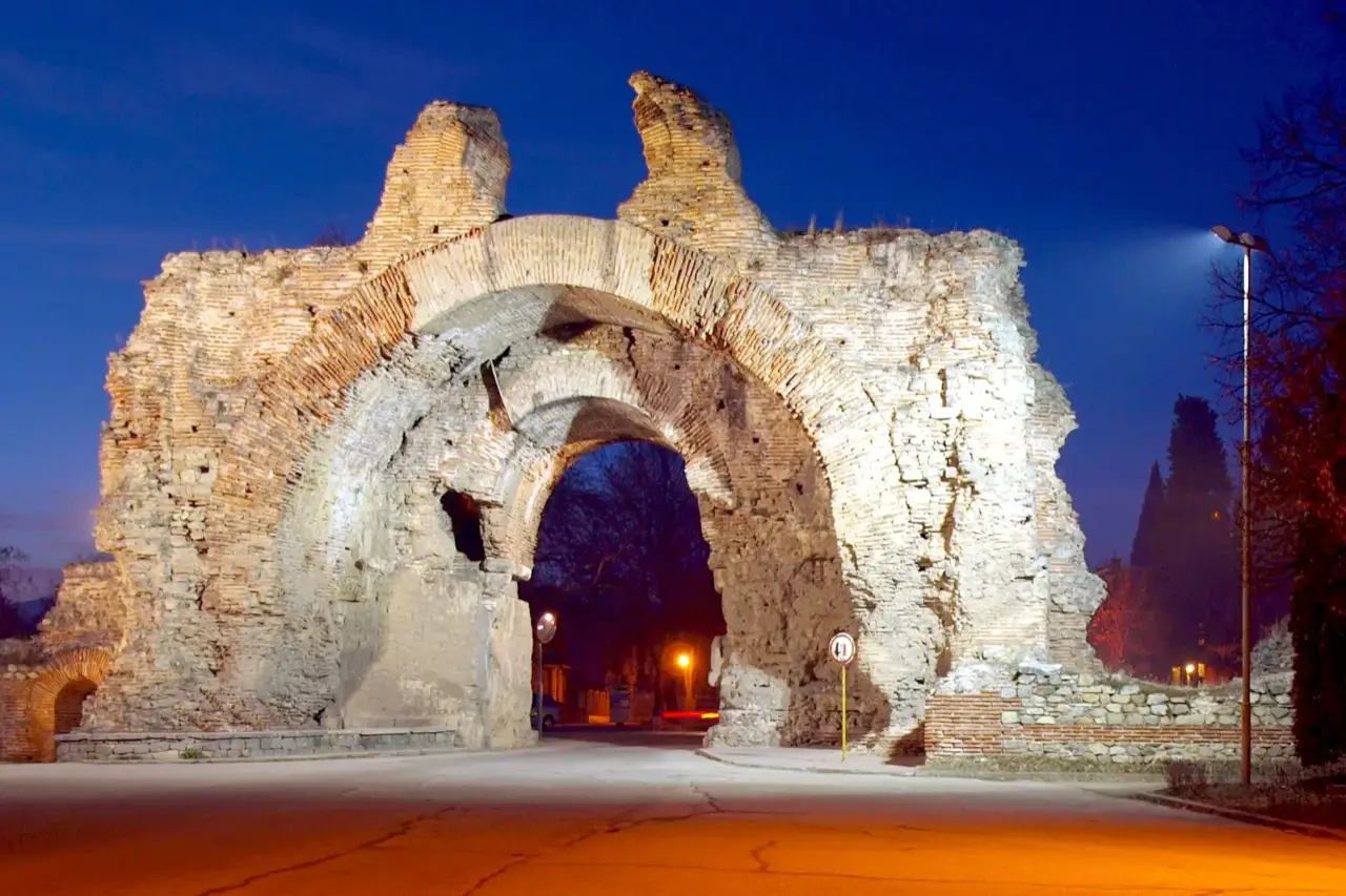 The illuminated southern Roman gate known as the Camels at Hisarya against the night sky