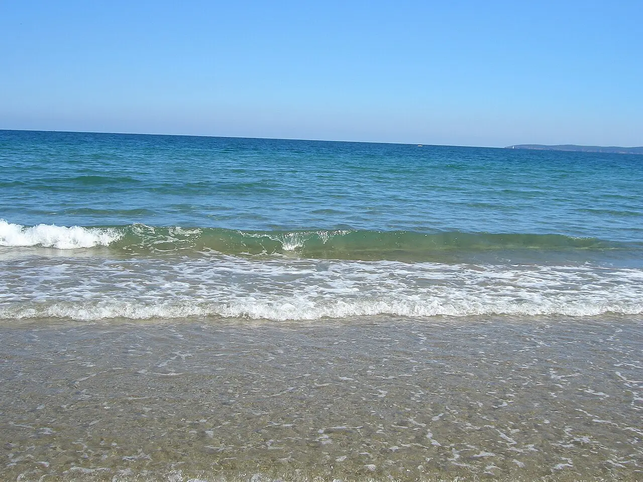 Calm blue water and a sandy curve at Kavatsite beach south of Sozopol on the Bulgarian Black Sea