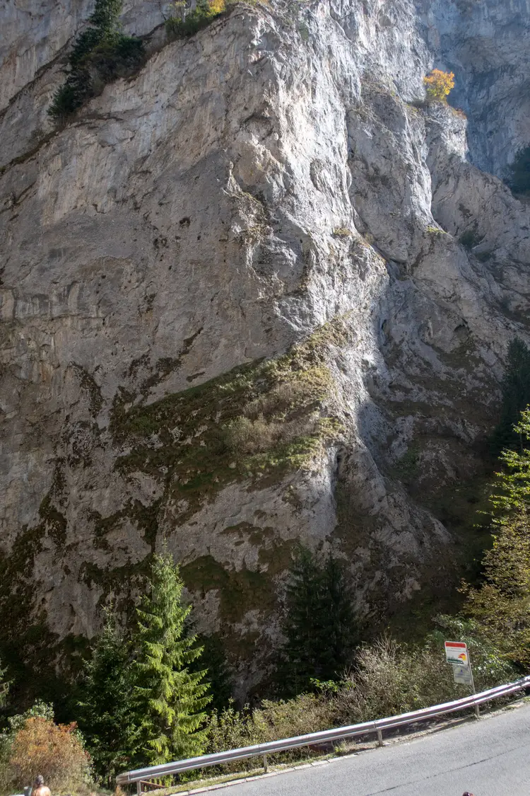The narrow road through Trigrad gorge running between sheer grey limestone walls