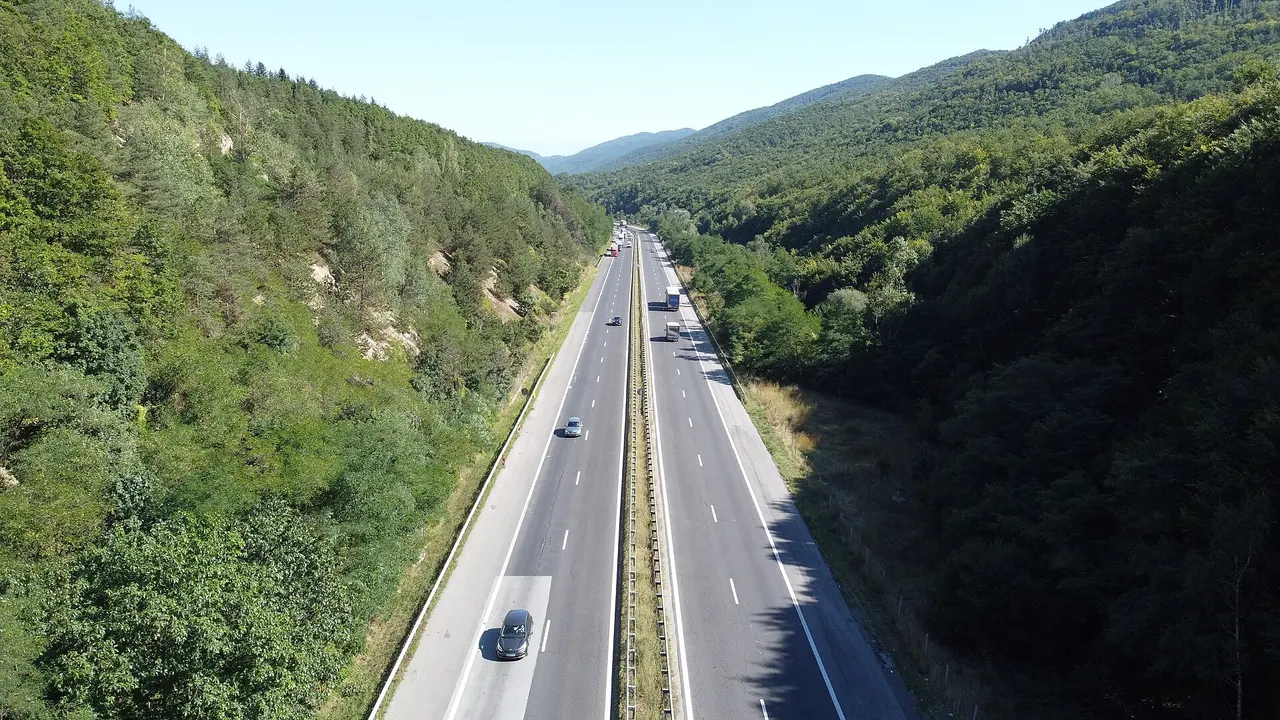 The A1 Trakia motorway in Bulgaria emerging from the Vitinya tunnel and curving through green forested hills