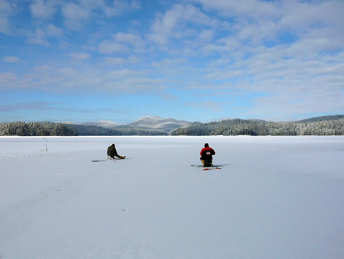 The Shiroka Polyana reservoir surrounded by forested Rhodope hills under a clear sky