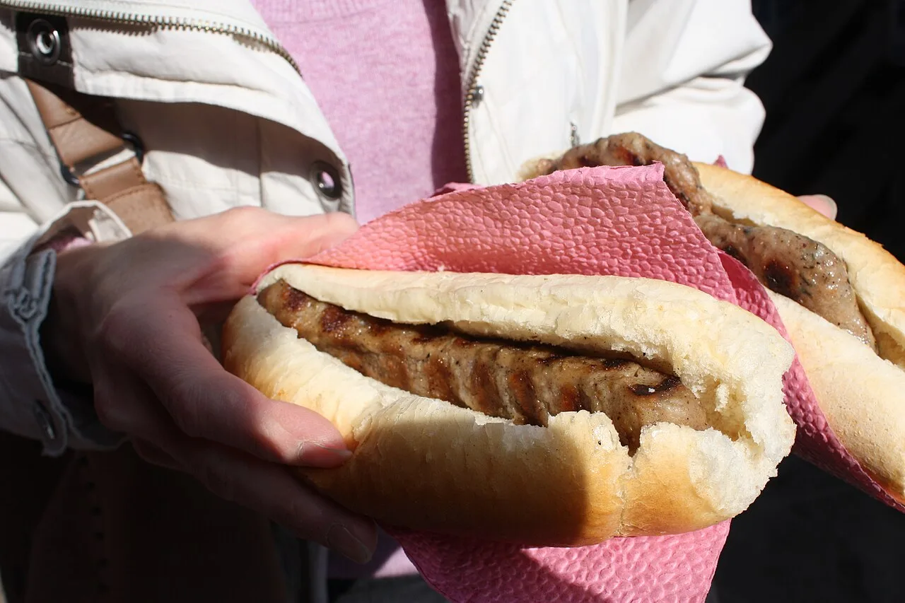 A plate of grilled kebapche sausages with a garnish at a Sofia grill, a cheap and filling Bulgarian meal