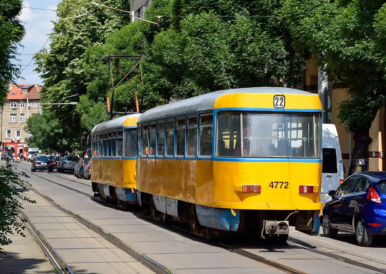 A yellow Tatra tram on a street in central Sofia, the cheap backbone of the city's public transport
