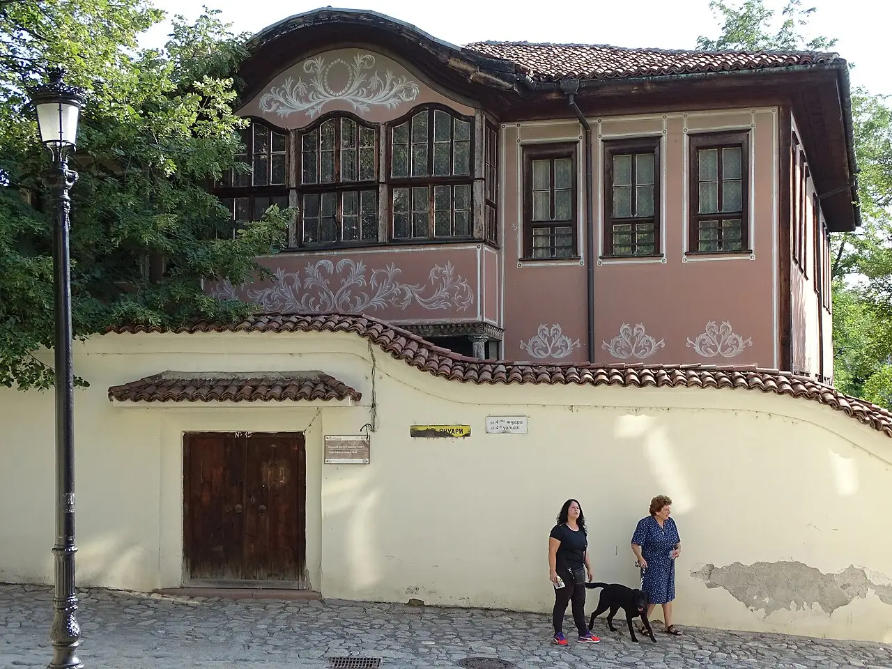 A quiet cobbled lane between painted National Revival houses in the Old Town of Plovdiv