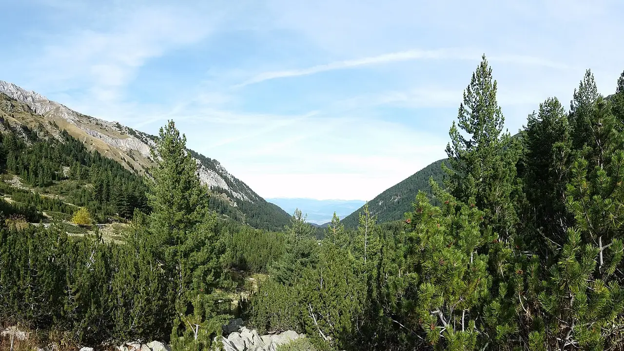 Jagged Pirin mountain ridges and alpine valleys under a summer sky