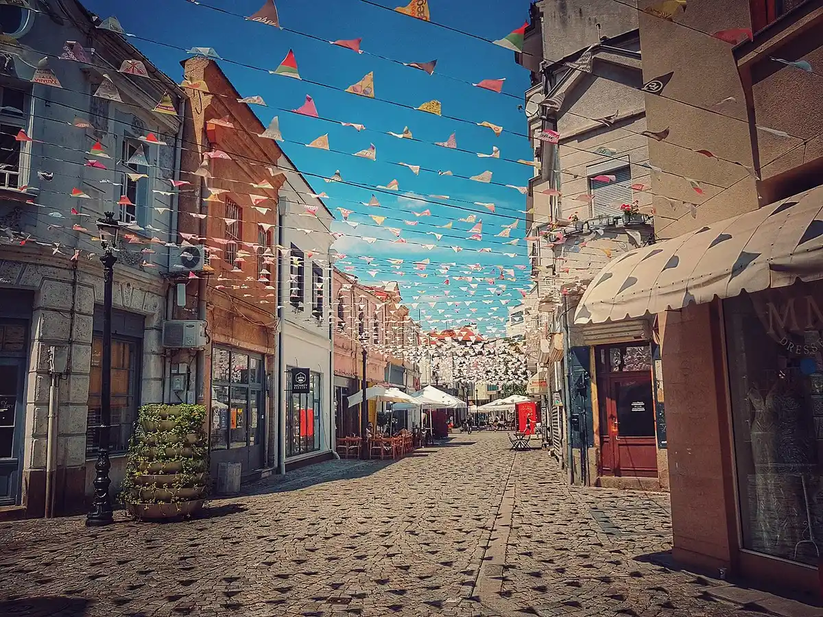 A narrow pedestrian lane in the Kapana creative district of Plovdiv lined with cafes and bars