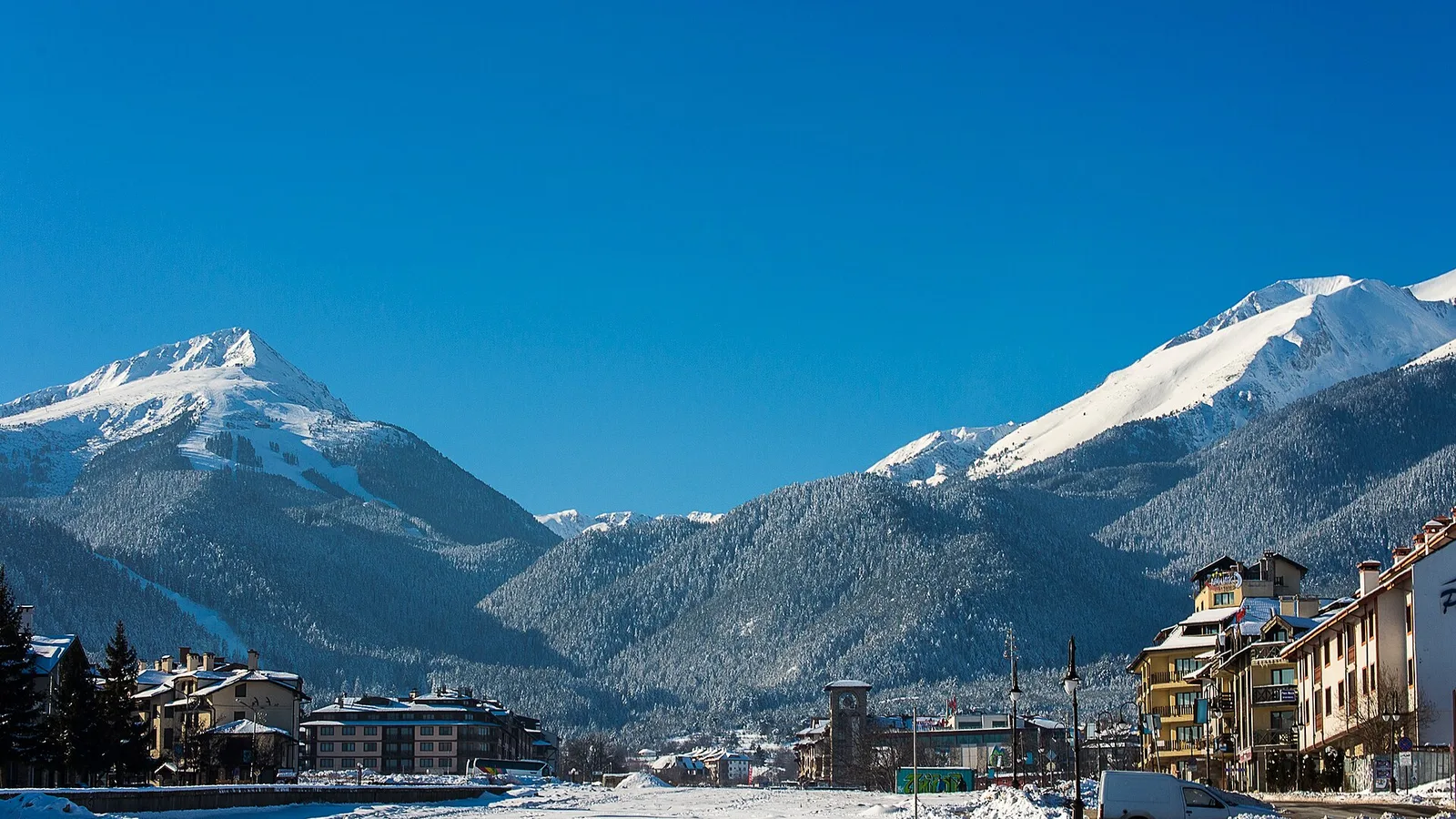 The town of Bansko in winter with the snow-covered Pirin peaks rising behind it