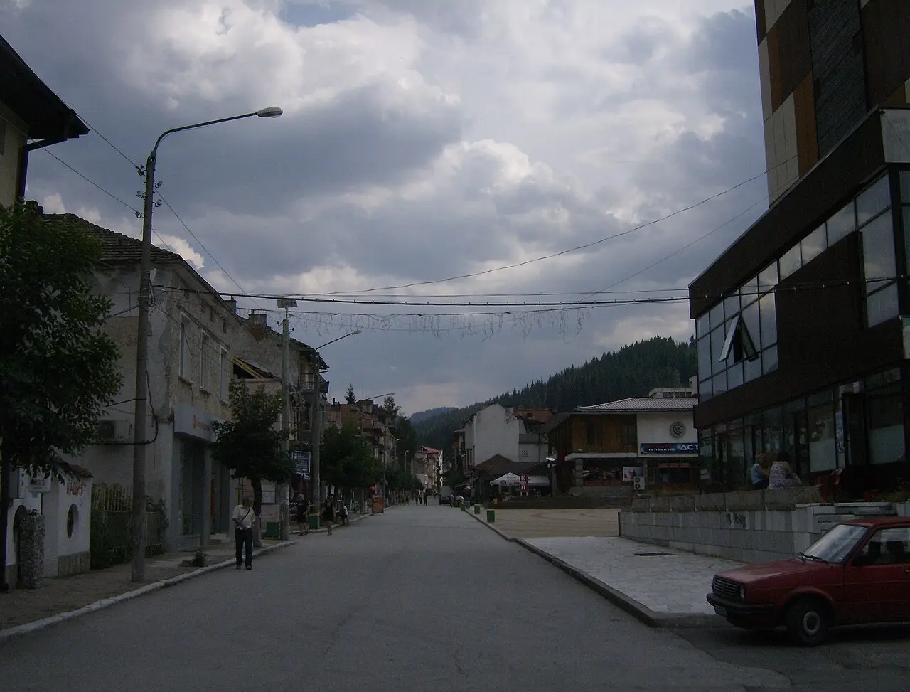 Rooftops of Chepelare town in the Rhodope Mountains with forested ridges behind