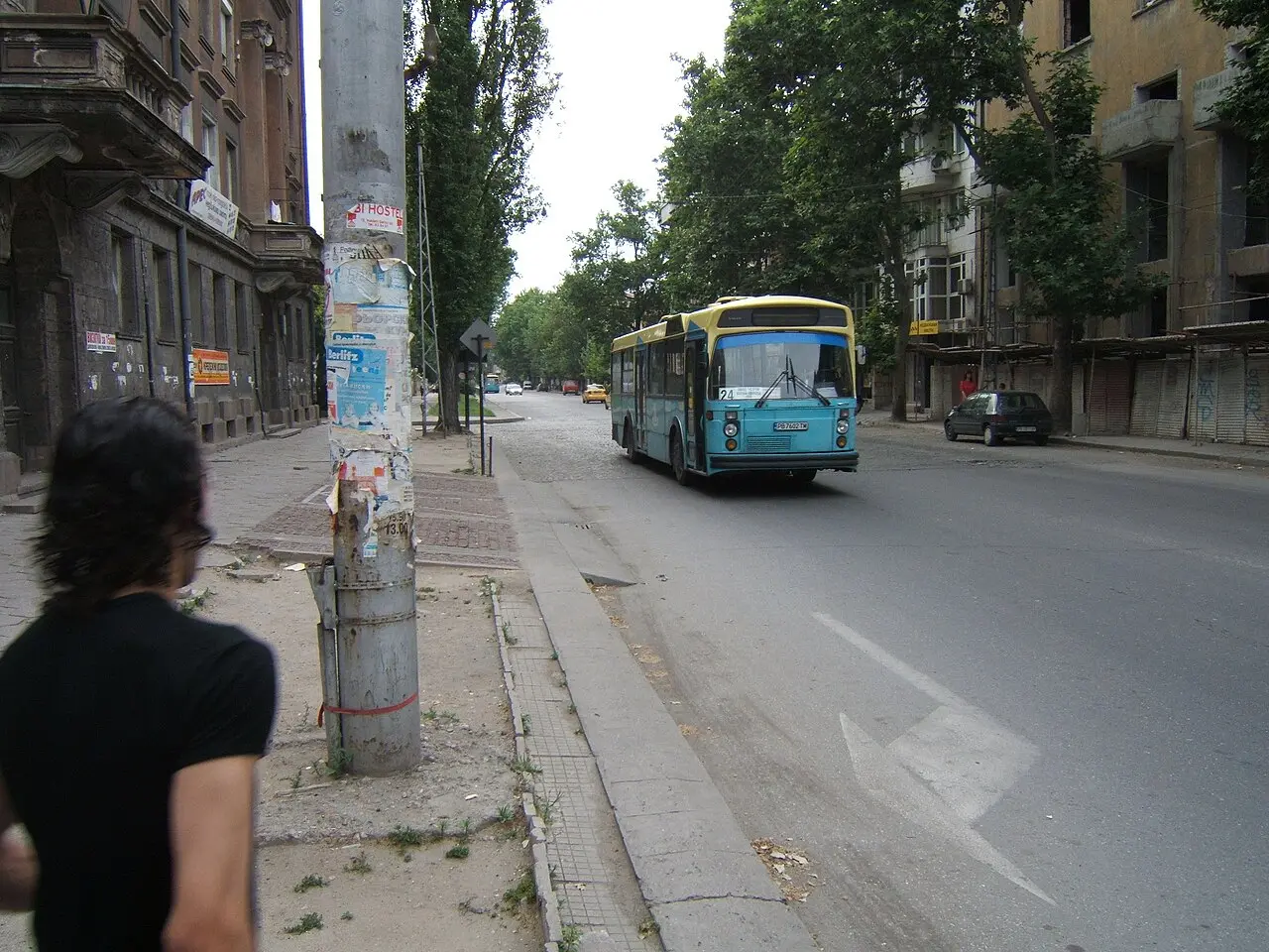A city bus on a street in Plovdiv under a clear sky