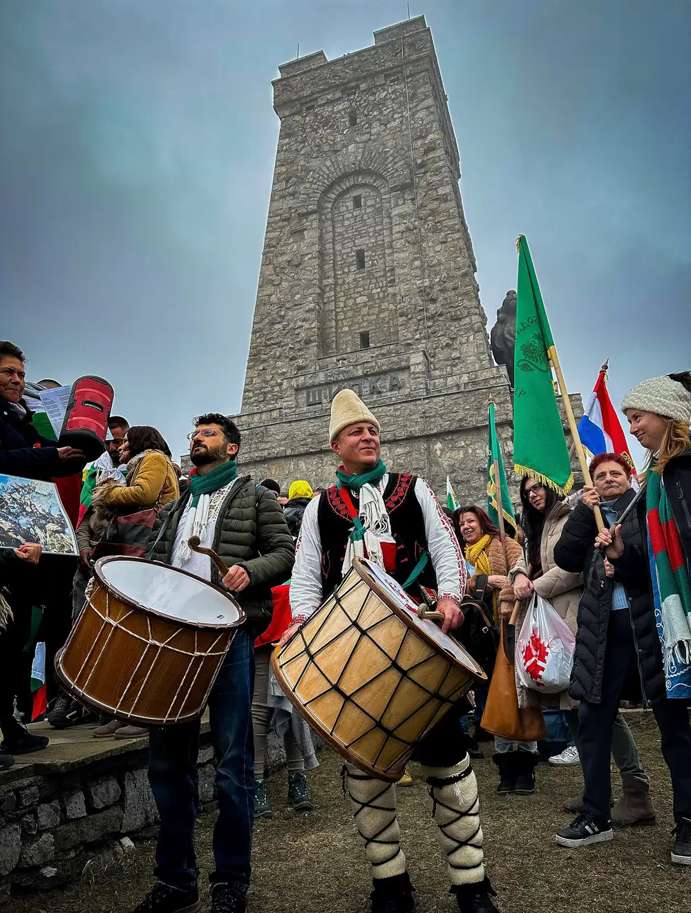 Dancers in traditional Bulgarian folk costume performing at a national holiday celebration