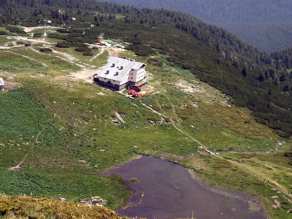 The Rila Lakes mountain hut at 2150 m with the chairlift arriving and a lake in the valley below
