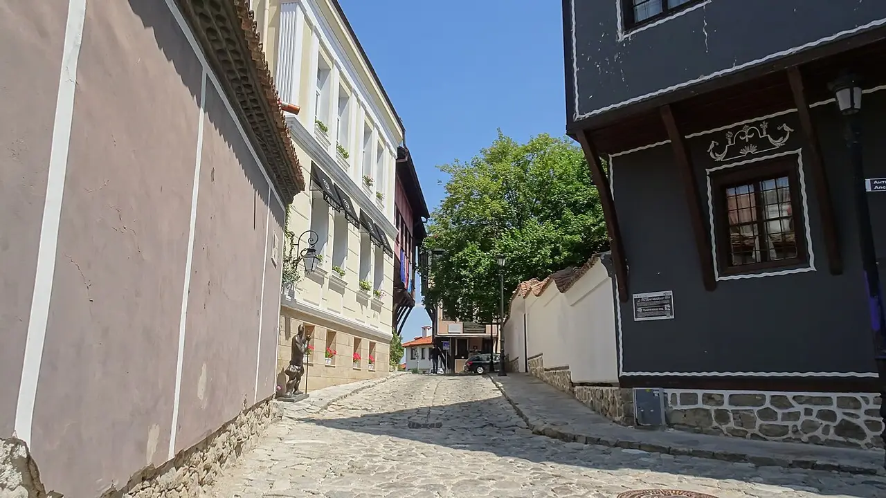 Painted Revival houses and tiled roofs of Plovdiv Old Town under a summer sky, looking across the historic quarter