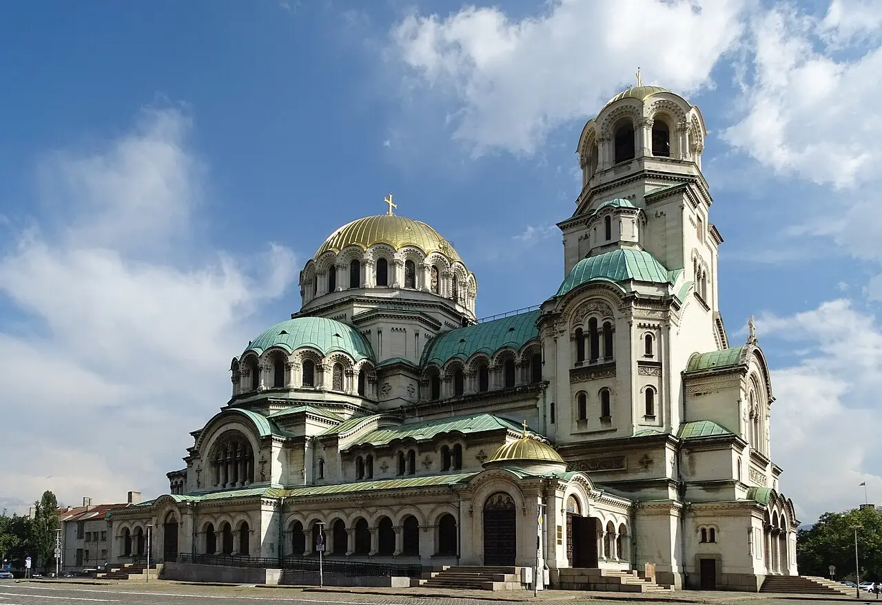 The gold-plated central dome and green copper half-domes of the Alexander Nevsky Cathedral in Sofia, seen from below