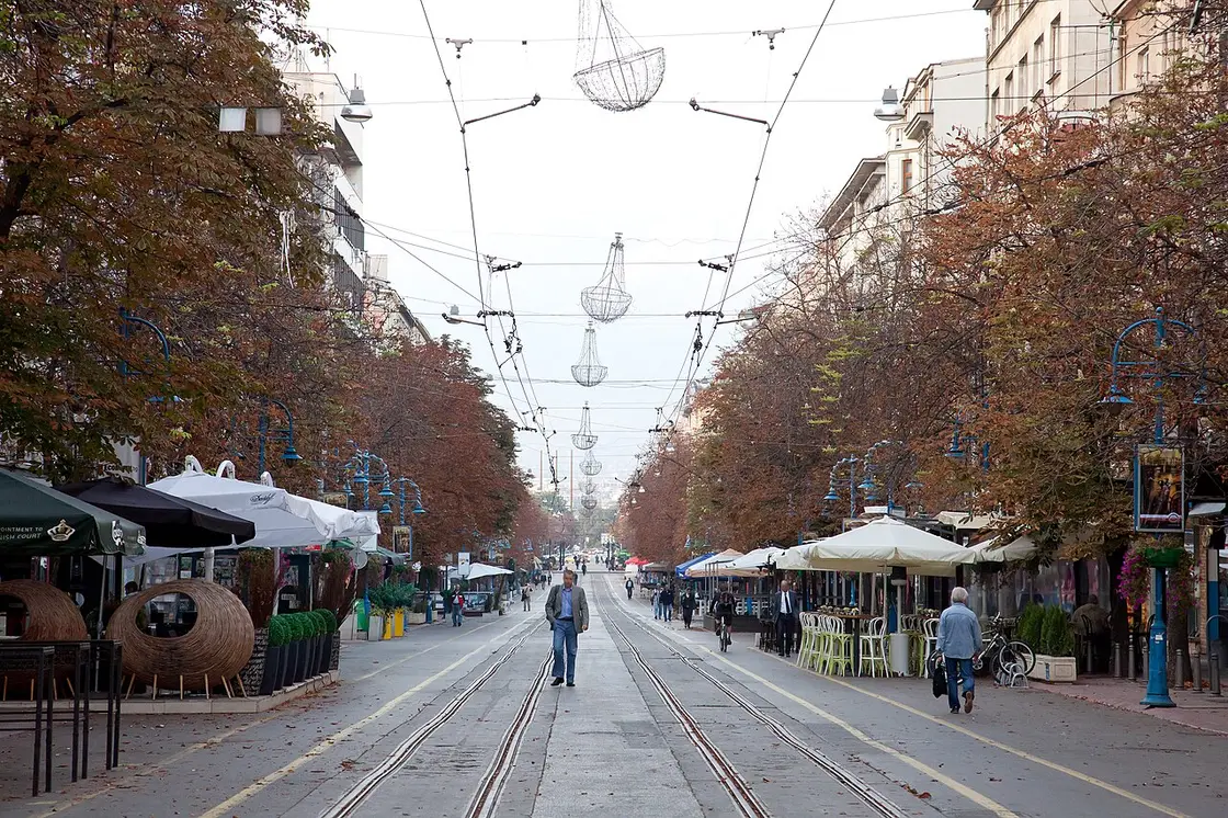 Cafe terraces and pedestrians on Vitosha Boulevard in central Sofia on a sunny afternoon