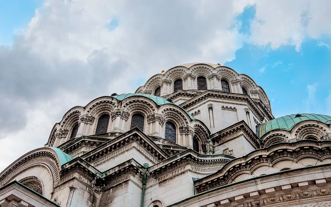 Looking up at the gilded central dome and green copper domes of the Alexander Nevsky Cathedral in Sofia