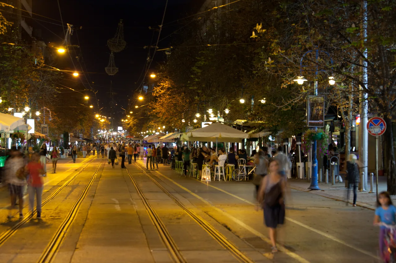 The pedestrian stretch of Vitosha Boulevard in Sofia after dark, lined with lit cafe terraces