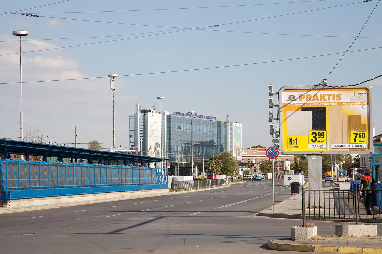 Sofia Central Bus Station, a glass office-style terminal building beside the boulevard, with the covered platforms in front
