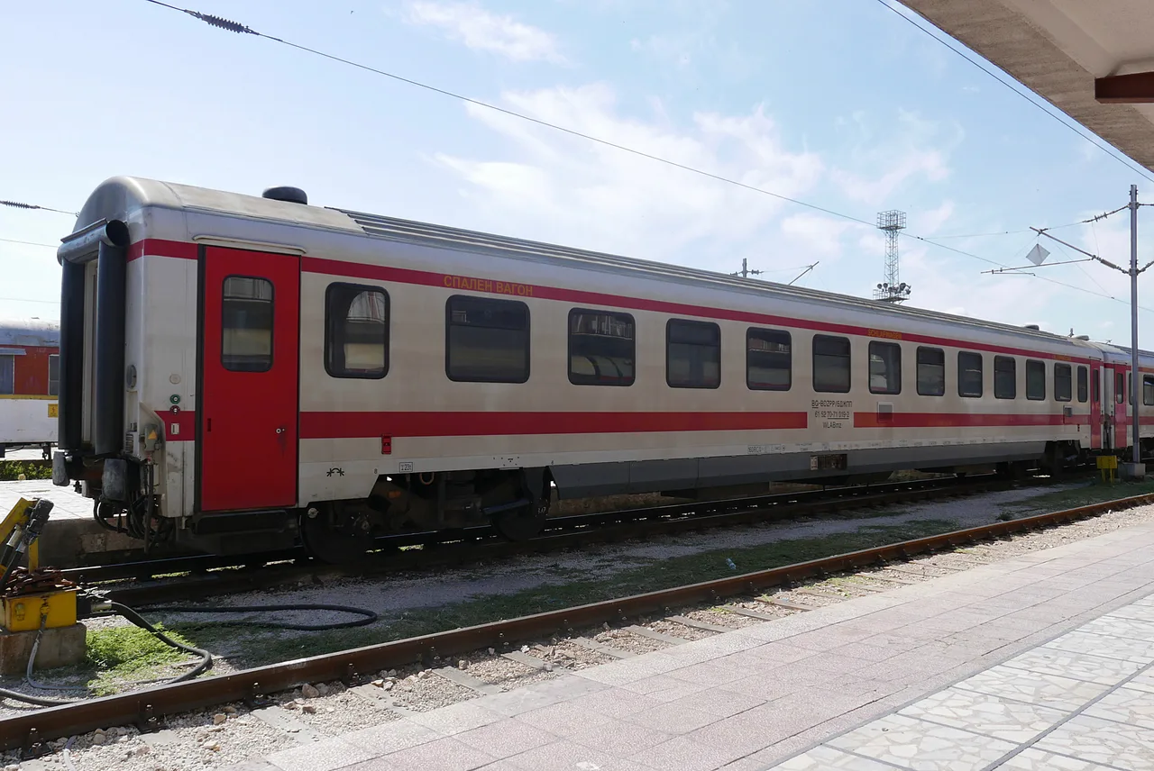 A blue BDZ sleeping car standing at the platform in Varna