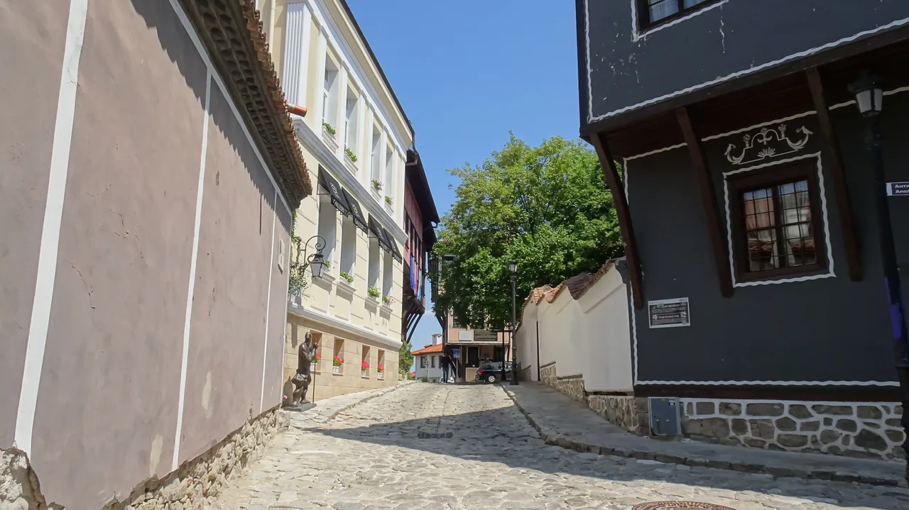 A cobbled lane in Plovdiv Old Town lined with colourful National Revival houses with overhanging upper floors