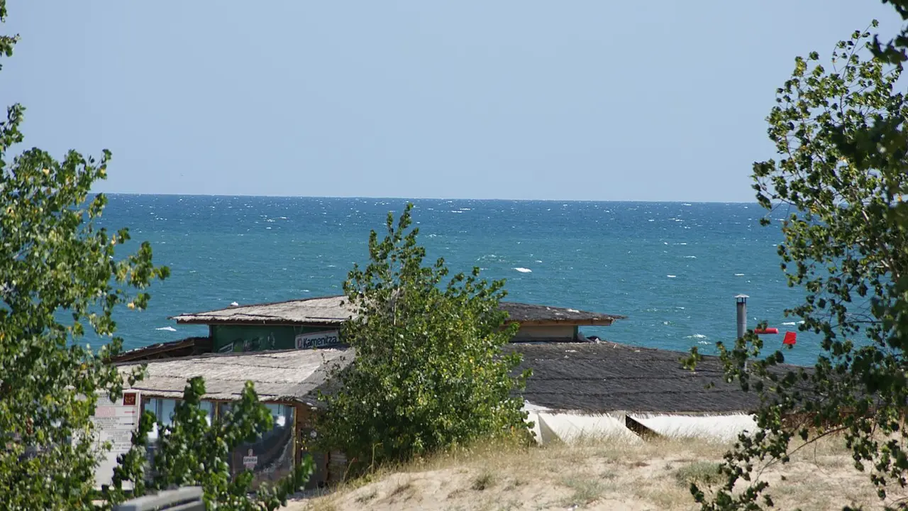 Hotel towers and a long sandy beach at Sunny Beach on the Bulgarian Black Sea under a clear summer sky