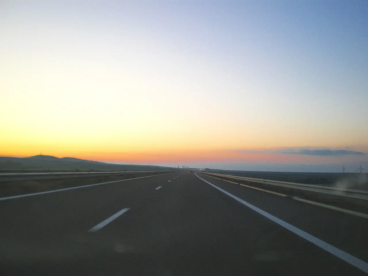 The A1 Trakia motorway stretching east through open Bulgarian countryside at sunrise