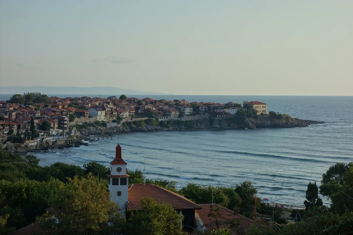 Aerial view of Sozopol: the old-town peninsula of red roofs on the left and the curving sandy bay and new town on the right