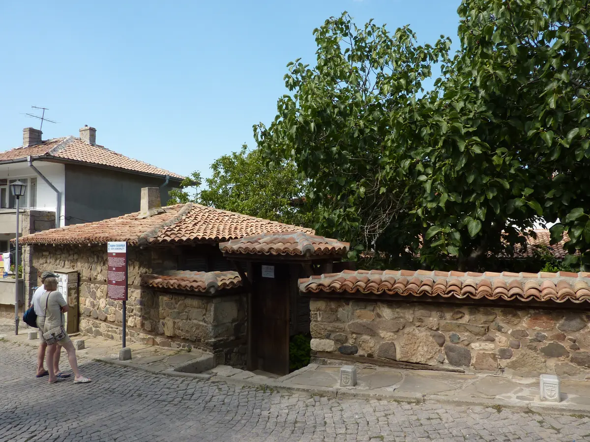 The low stone Church of the Holy Mother of God in Sozopol seen from the cobbled street, half sunk below the lane