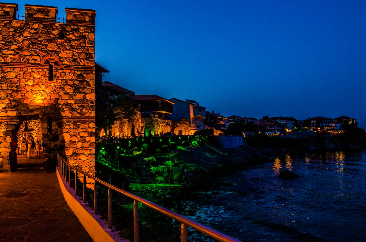 The reconstructed stone Southern Fortress Wall and square watchtower of Sozopol standing above the sea