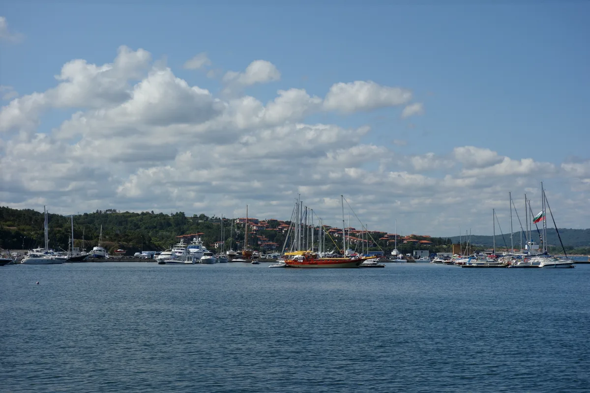 Small fishing and pleasure boats moored side by side in the harbour below Sozopol old town