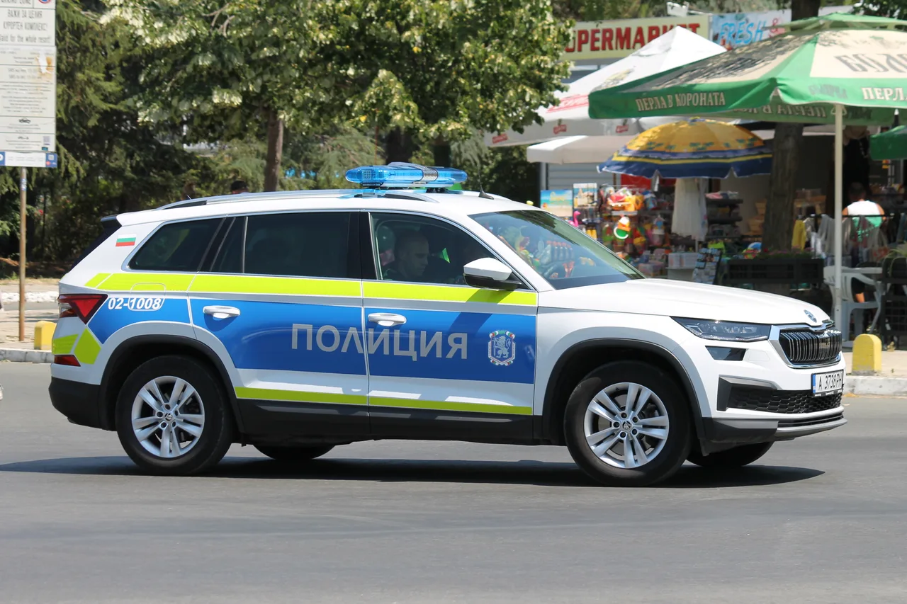 A modern Bulgarian police car parked beside a kiosk on the strip at Sunny Beach