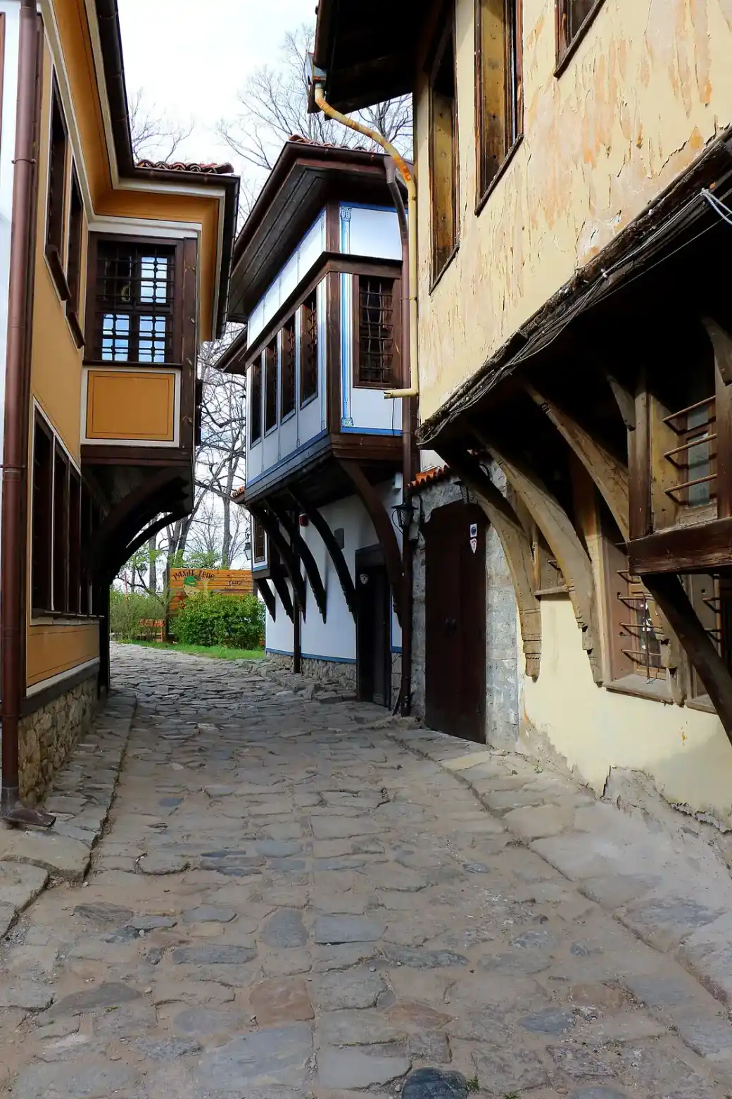 A stone-paved lane climbing between Revival-era houses in the Old Town of Plovdiv