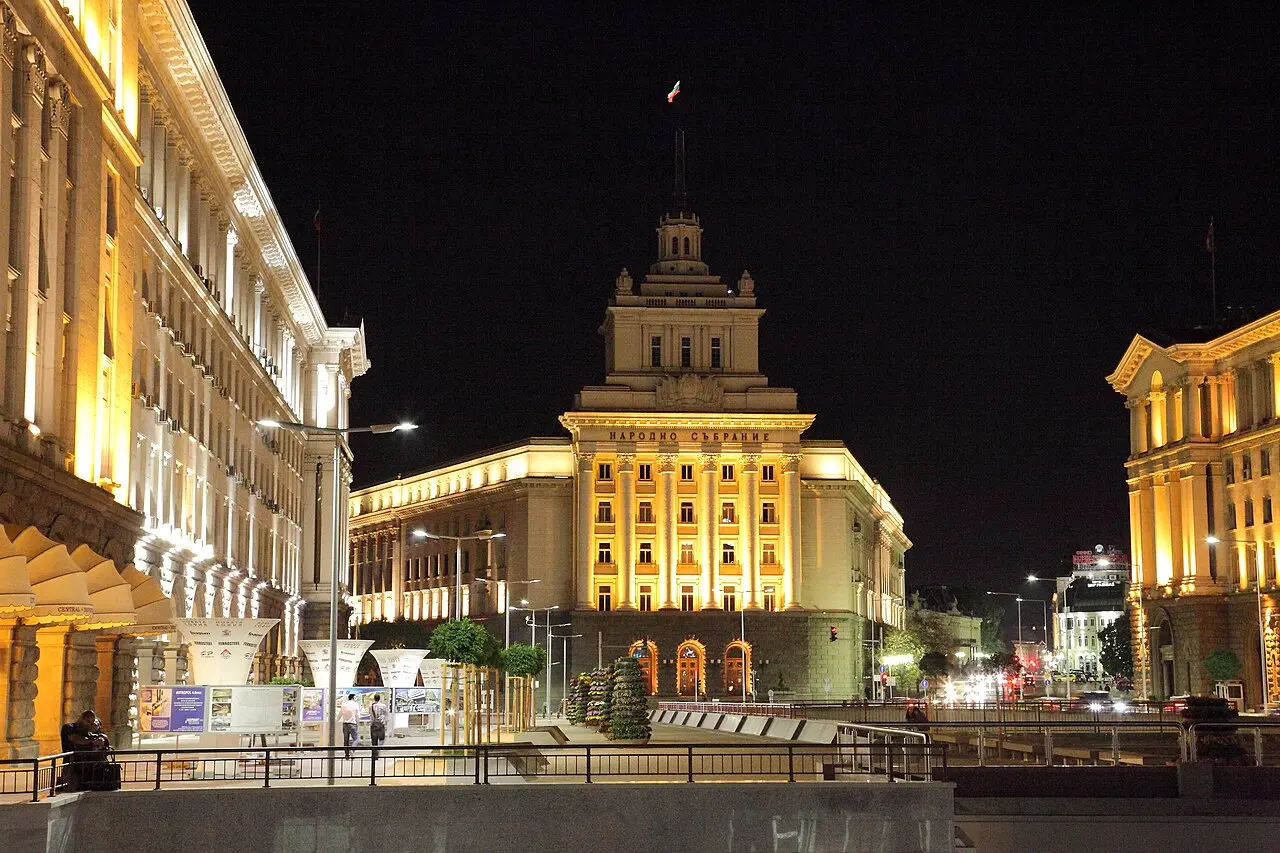 Independence Square (the Largo) in Sofia lit up at night, with the former Party House at the centre