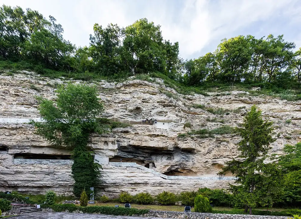 Rock-cut cells and walkways on the limestone cliff face of Aladzha Monastery north of Varna