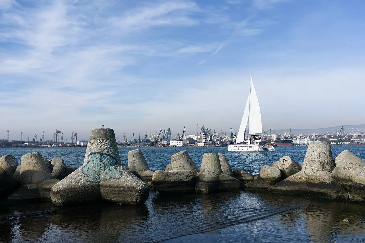Cranes and ships in the commercial Port of Varna with the Black Sea harbour in winter light