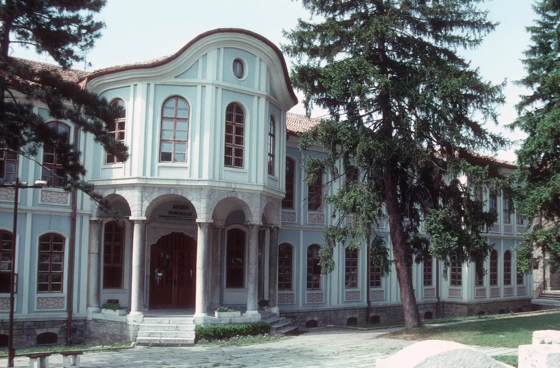 A blue-painted National Revival mansion in Veliko Tarnovo with a curved bay and arched windows, now a museum