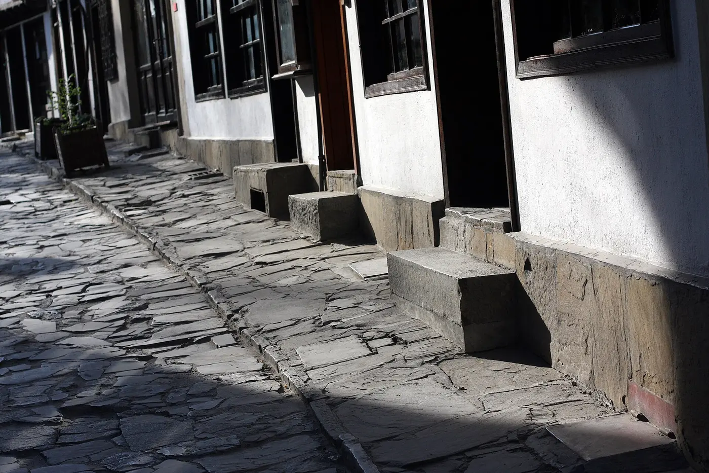 A cobbled lane of whitewashed craft houses with stone steps in the Samovodska Charshia quarter of Veliko Tarnovo