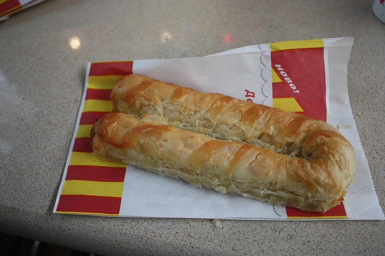 Two coils of freshly baked banitsa, the flaky Bulgarian cheese pastry, on a bakery counter in Sofia